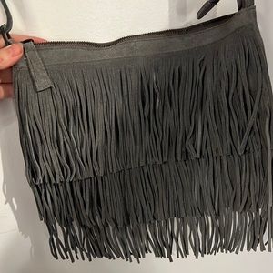 Grey suede bag with fringe.